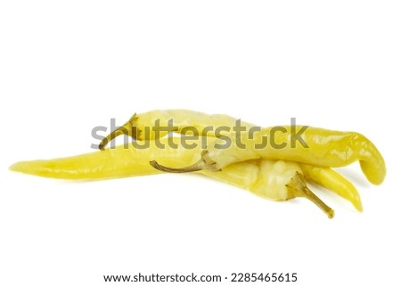 Pile of pickled yellow peppers isolated on white background