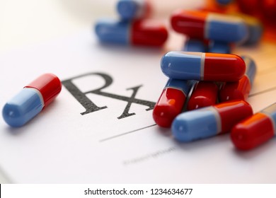 Pile of pills fall out from jar to paper list closeup. Life save lab food additives lie at table clinic prescribe rx symbol concept