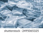 A pile of plastic containers on a blue background ready for packaging food products. All containers are of different sizes and shapes. Industrial food packaging concept background