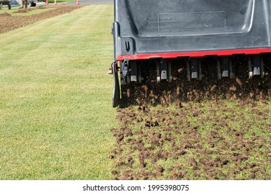 Pile of plugs of soil removed from sports field. Waste of core aeration technique used in the upkeep of lawns and turf