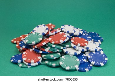 Pile Of Poker Chips On Green Paper