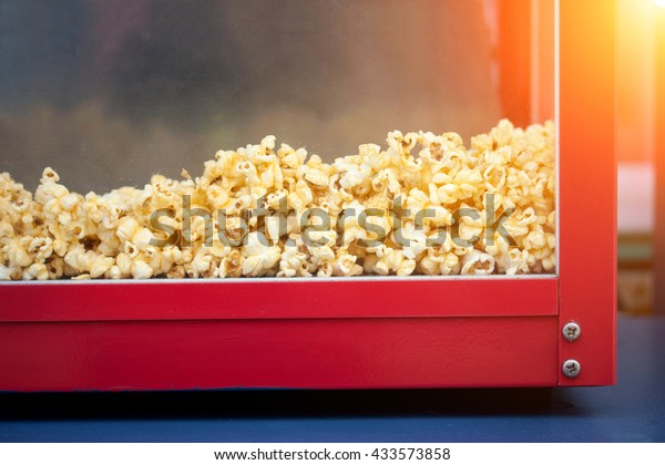 A pile of popcorn in\
a popcorn maker.