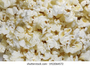 A pile of popcorn on a white background Scattered popcorn texture background Selective focus