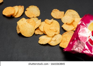 Pile Of Potato Chips. Crisps On Background. Potato Chips Is Snack In Bag