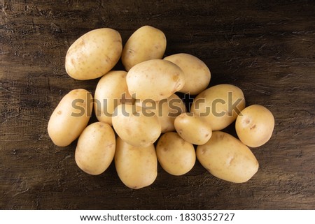 Pile of potatoes lying on rustic background. Top view