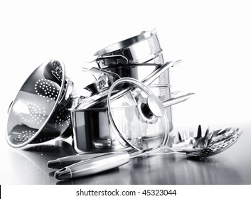 Pile Of Pots And Pans Against A White Background