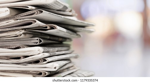 Pile of printed newspapers on background - Shutterstock ID 1179335374