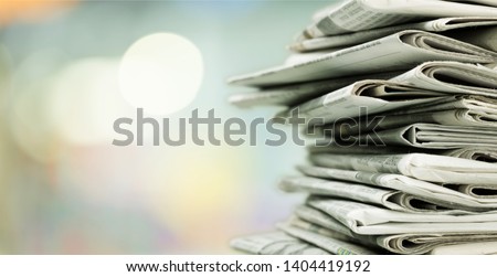 Pile of printed newspapers on background