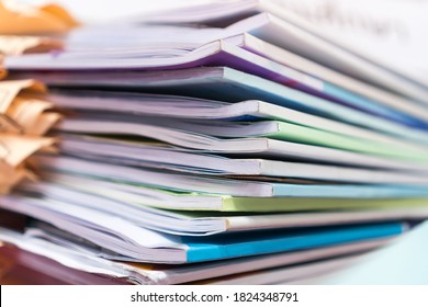 Pile of publication books or documents report papers waiting be managed on desk in busy office. Concept of workload in business finacial paperwork - Shutterstock ID 1824348791