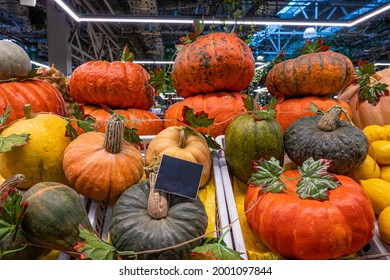 A Pile Of Pumpkins, A Stall With A Ripe Pumpkin Close-up At A Farmer's Market. Copy Space. Mockup.