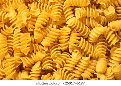 Pile of raw fusilli pasta close-up. Italian pasta, pasta cones texture, top view - Powered by Shutterstock