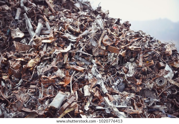 Pile of recycled scrap metal on a garbage\
recycled plant. Toned\
image\
