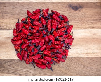 Pile Of Red Birds Eye Chili On A Wooden Background. Close Up.