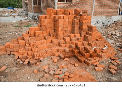 Pile of red bricks on a construction site. brick stacked background texture