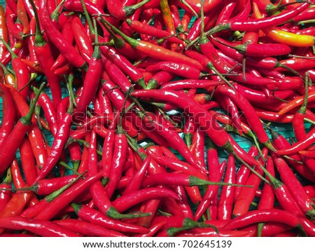 Pile of Red small Chili in the tray. Texture background of red pepper heap.
