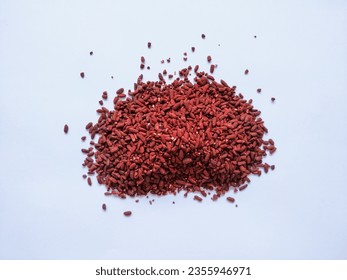 A Pile of Red Yeast Rice in the White Background