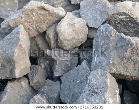A pile of rough, angular gray and dark gray rocks