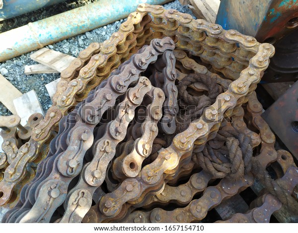 pile of rusty old machine\
chains.\
the image is out of focus because it is using a smartphone\
camera