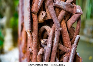 A pile of rusty water pipes and scrap iron twisted together
