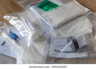 A pile of sample containers and request forms for medical test.