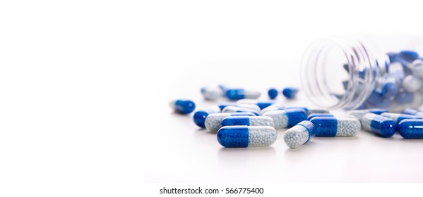 Pile of scattered capsules on a white background. capsules isolated white capsule pharmacy bottle pill drug concept