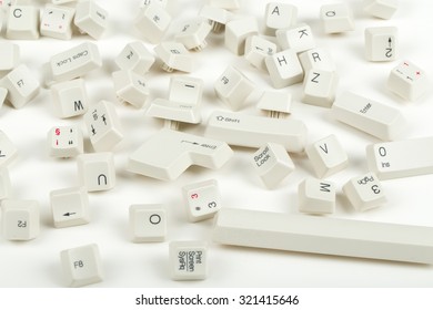 Pile Of Scattered White Keyboard Keys On White Background