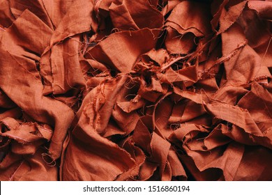 A Pile Of Scraps Of Red Linen Fabric. Fabric Background. Make Clothes