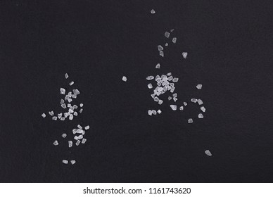 A Pile Of Sea Salt Isolated On A Black Board, Top View