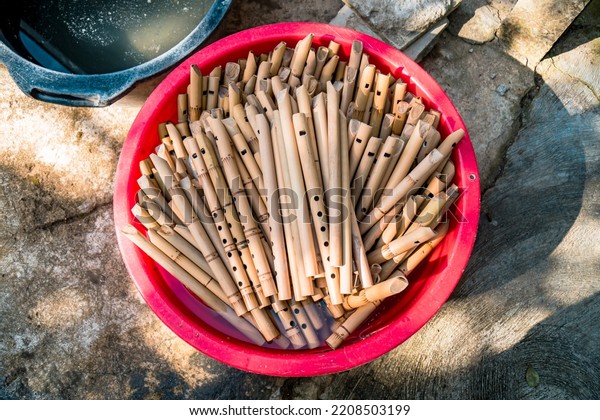 \
Pile of\
semi-finished bamboo flute in a bucket, handmade bamboo flute\
production process by craftsmen, bamboo flute soaked in water\
before being dried, finished and\
marketed