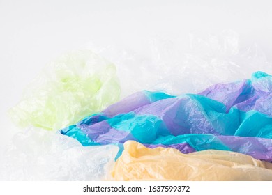 A Pile Of Single Use Plastic Garbage Including Food Packages And Carrier Bags On White Background With Copy Space. Pollution Concept.