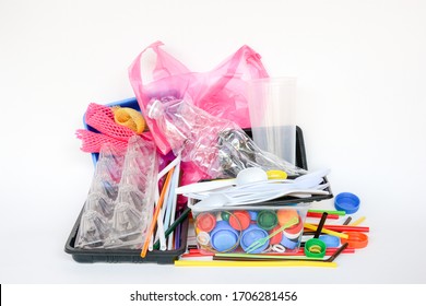 A Pile Of Single Use Plastic Trash Including  Water Bottles, Drinking Straws, Food Packages Fork, Spoon, Caps Cups And Carrier Bags On White Background. Pollution Concept.