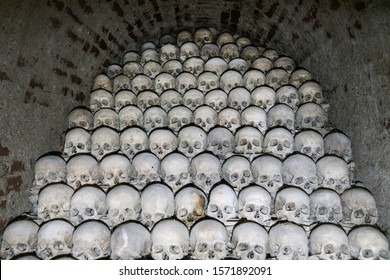 A pile of skulls laid out in rows in the catacombs. Symbol of death, war, terror and evil