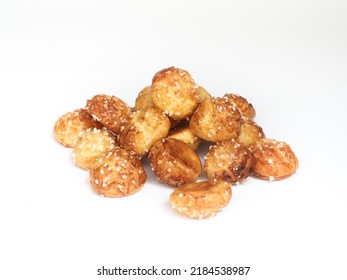 pile of small choux pastry coated with pearl sugar on white background