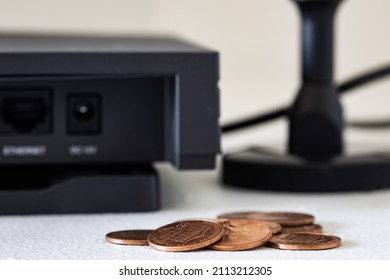 Pile Of Small Coins In Front Of Helium Hotspot Cryptocurrency Miner Device. Association Of Just Making Pennies From Virtual Currency Trading