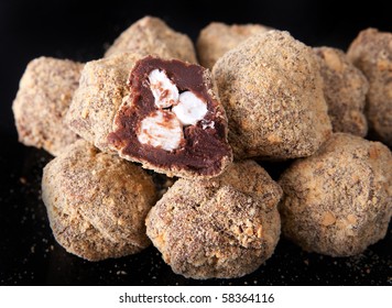 Pile Of Smores Truffles With Inside View Over A Black Background