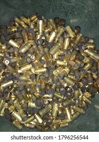 Pile Of Spent Bullet Casings On A Green Background