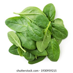 Pile of spinach leaves close-up on a white background. Top view.