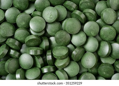 Pile of spirulina tablets background