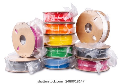Pile stack of vacuum sealed PLA 3d printing filament material on recyclable cardboard paper coils isolated on white background. FDM printer technology modern and future concept. 