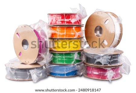 Pile stack of vacuum sealed PLA 3d printing filament material on recyclable cardboard paper coils isolated on white background. FDM printer technology modern and future concept. 