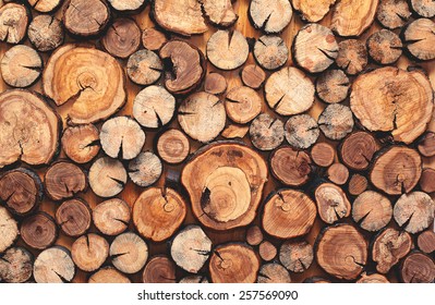 pile stacked natural sawn wooden logs background, top view