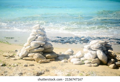 Pile of stone on the beach on the lighthouse Phare des Baleines on the isle of Ile de Ré in France on a sunny summerday