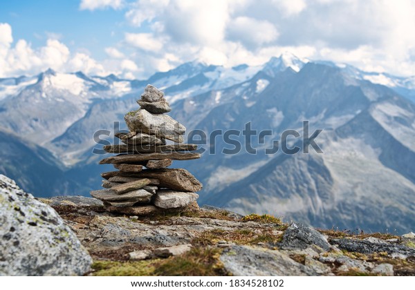A pile of stones (also called cairn, Steinmännchen or\
Steinmandl) in the austrian alps, used as a hiking marker. They are\
also found in buddhist temples and will be used as zen stones for\
meditation. 