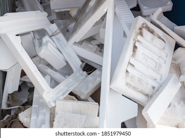 A pile of styrofoam boxes and packaging discarded as rubbish. Environmental pollution, the need to recycle waste concept image. Close-up, selective focus.