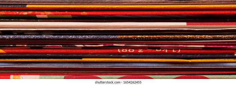 Pile of supermarket advertising brochures. Folded, stacked pages of discount flyers. paper wastage, signifying energy consumption, resources, environmental conservation concepts