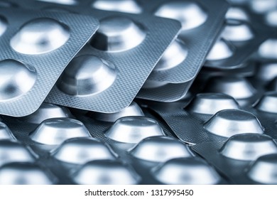 Pile Of Tablets Pill In Blister Packaging To Protect Medicine From Light. Silver Aluminium Foil Blister Pack. Pharmaceutical Industry. Pharmacy Products. Drug Recall And Withdrawal From Market Concept