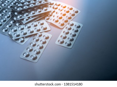 Pile Of Tablets Pill In Blister Packaging To Protect Medicine From Light. Silver Aluminium Foil Blister Pack. Pharmaceutical Industry. Pharmacy Products. Drug Recall And Withdrawal From Market Concept