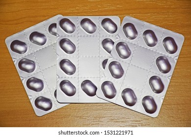 Pile Of Tablets Pill In Blister Packaging To Protect Medicine From Light. Silver Aluminium Foil Blister Pack. Pharmaceutical Industry. Pharmacy Products. Drug Recall And Withdrawal From Market Concept