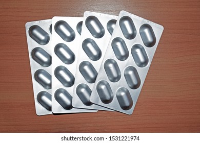 Pile Of Tablets Pill In Blister Packaging To Protect Medicine From Light. Silver Aluminium Foil Blister Pack. Pharmaceutical Industry. Pharmacy Products. Drug Recall And Withdrawal From Market Concept