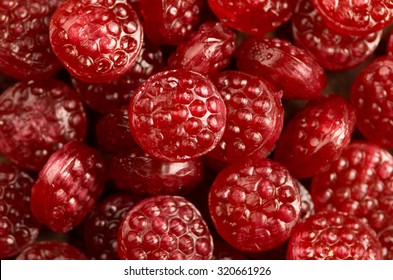 Pile Of Tasty Delicious Raspberry Hard Candy Lying On Wooden Surface.